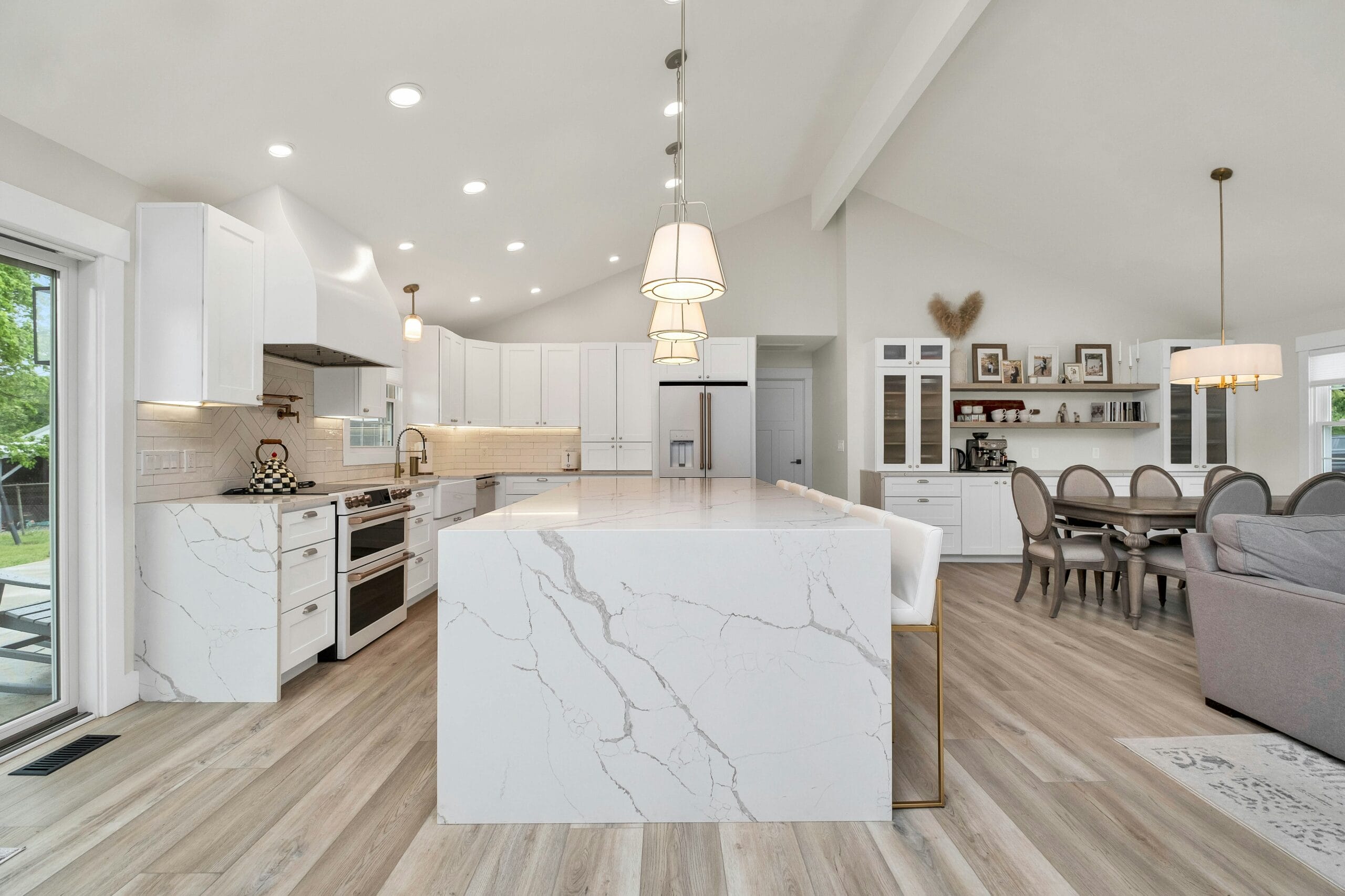White stone slab waterfall kitchen island in a modern Portland kitchen